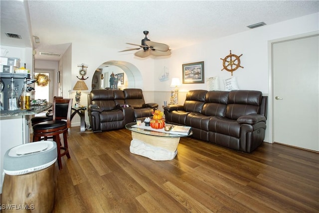 207 SE 20th Pl, Cape Coral, FL 33990 - living area featuring a textured ceiling, wood finished floors, ceiling fan, and arched walkways