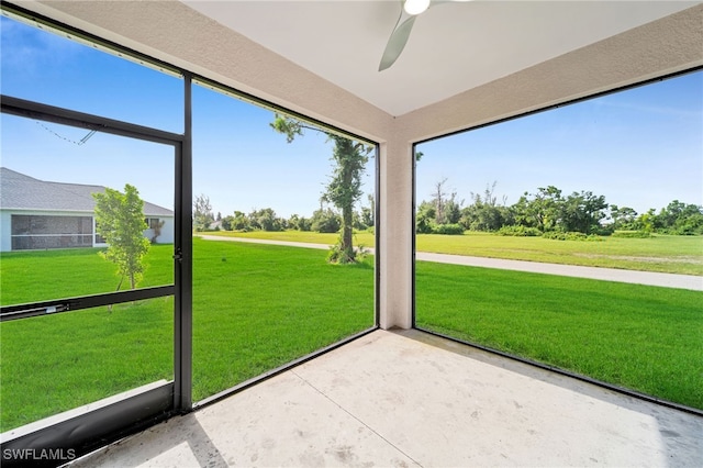 unfurnished sunroom with ceiling fan