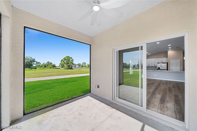 unfurnished sunroom featuring vaulted ceiling and ceiling fan