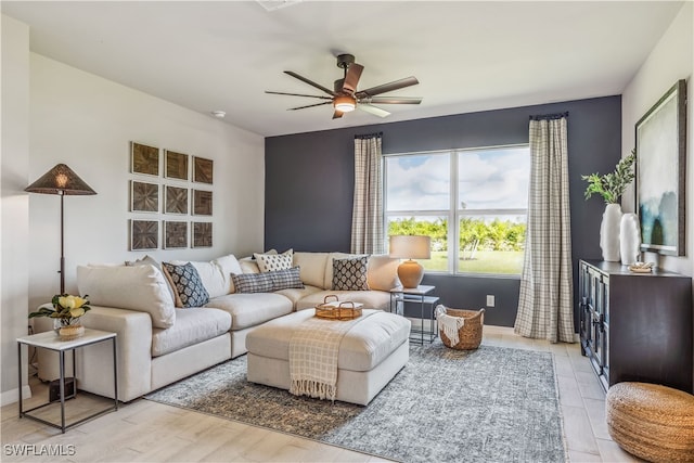 living room featuring ceiling fan and light wood-type flooring