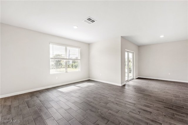 unfurnished room featuring dark wood-type flooring