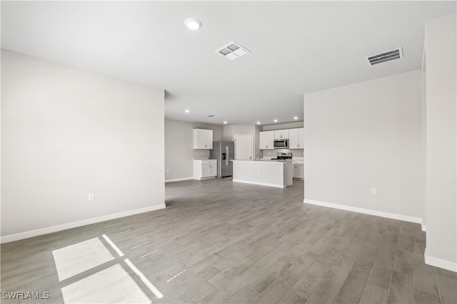 unfurnished living room featuring hardwood / wood-style flooring