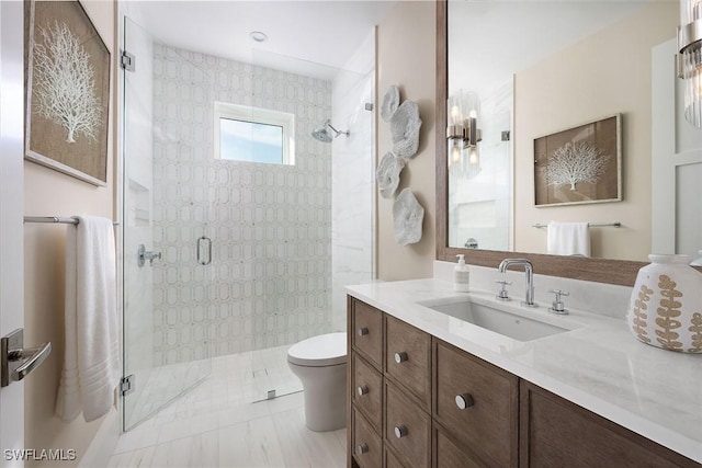 bathroom with vanity, a shower with shower door, and toilet