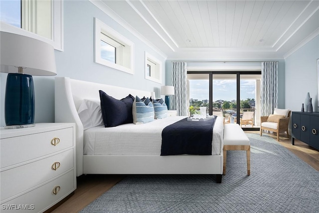 bedroom with crown molding, hardwood / wood-style floors, a tray ceiling, and wooden ceiling