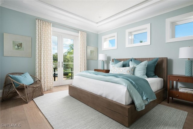 bedroom featuring access to exterior, wood-type flooring, and french doors