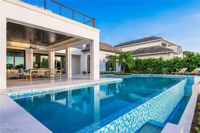 view of pool featuring ceiling fan, outdoor lounge area, and a patio