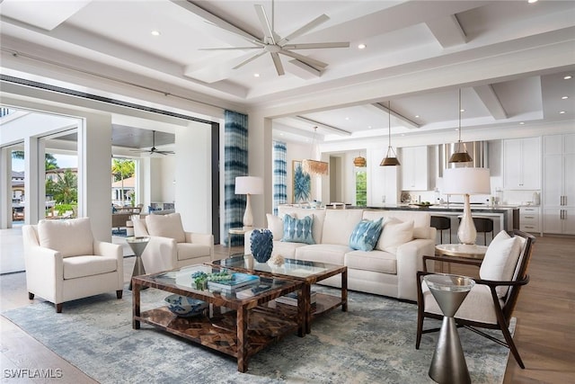 living room featuring wood-type flooring, a wealth of natural light, and ceiling fan