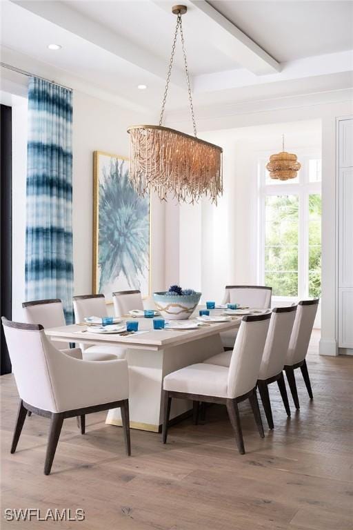 dining area with beamed ceiling and light hardwood / wood-style flooring