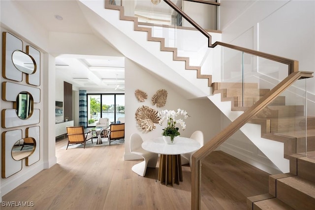 stairway featuring hardwood / wood-style flooring and beam ceiling