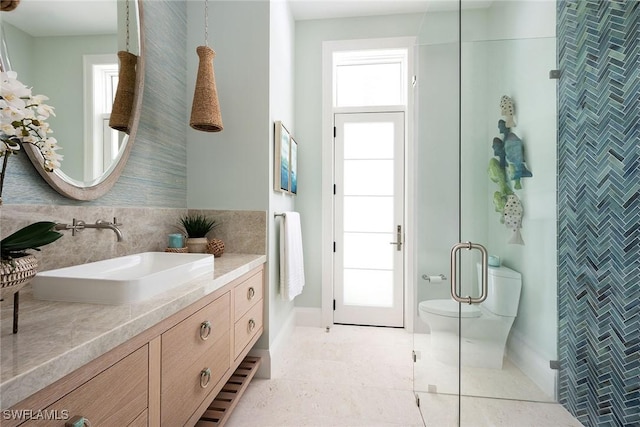 bathroom featuring vanity, tile patterned flooring, a shower with door, and toilet