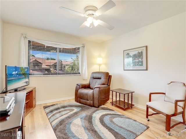 sitting room with light hardwood / wood-style flooring and ceiling fan