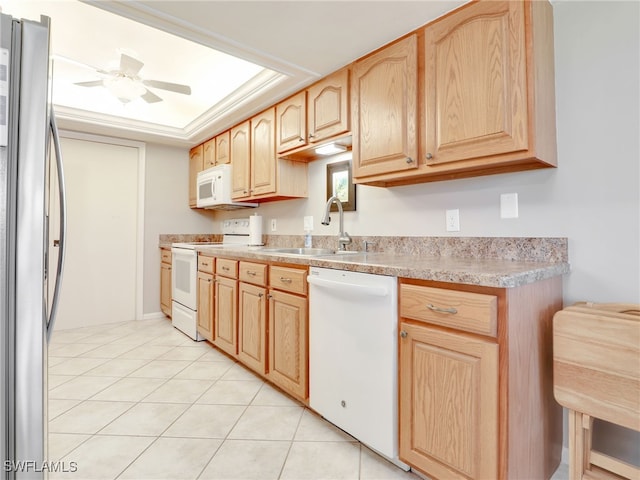 kitchen featuring white appliances, sink, ceiling fan, light tile patterned floors, and light brown cabinets