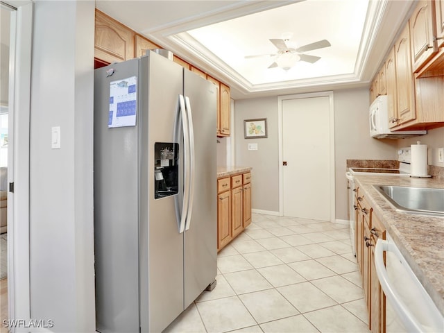 kitchen featuring ceiling fan, light tile patterned floors, a raised ceiling, light brown cabinetry, and white appliances