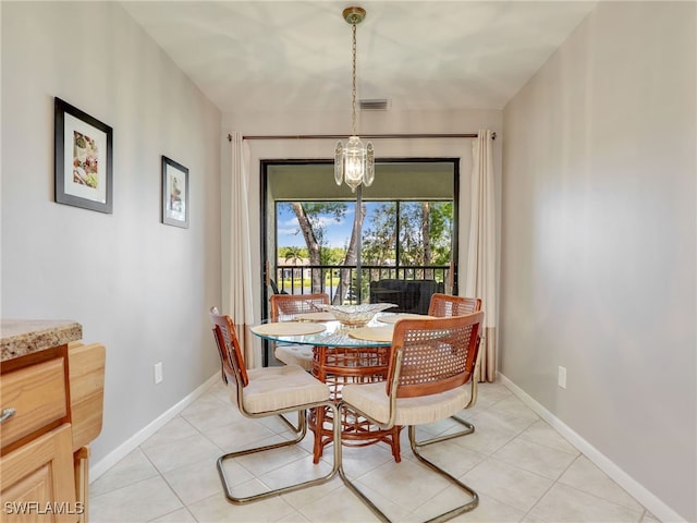 tiled dining space with a notable chandelier