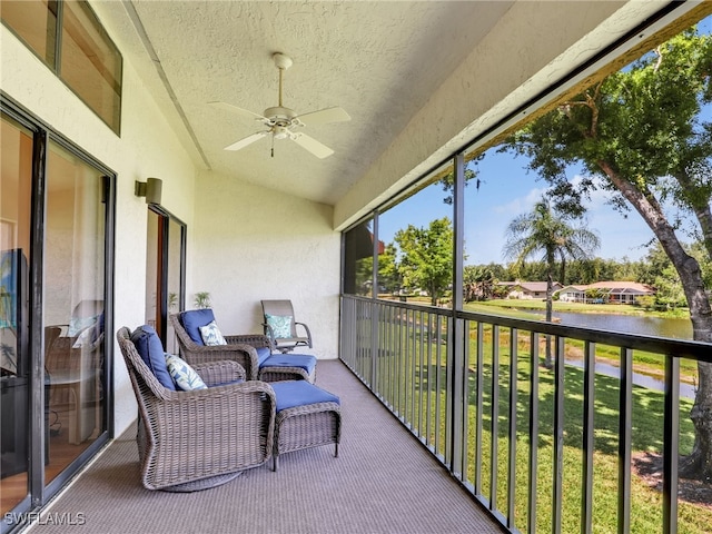 balcony with a water view and ceiling fan