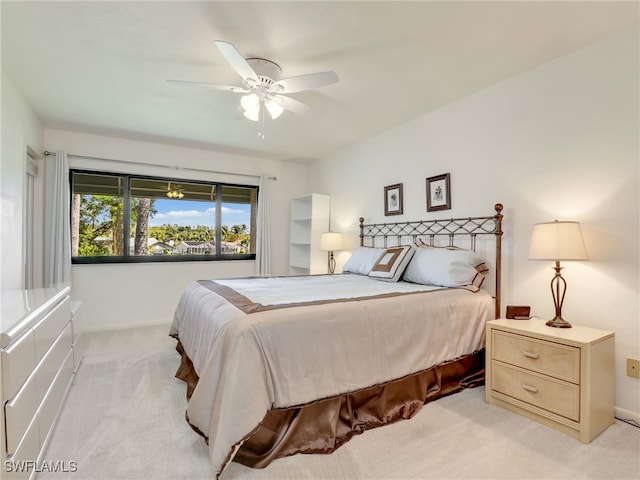 bedroom with light carpet and ceiling fan