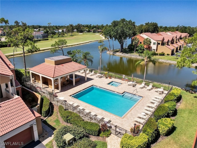 view of pool with a water view and a patio