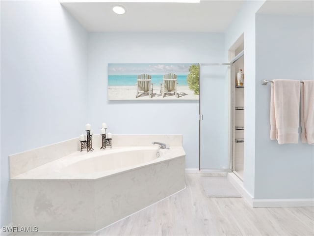 bathroom with a water view, shower with separate bathtub, and wood-type flooring