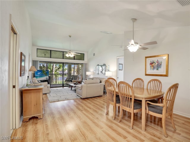 dining area with ceiling fan, lofted ceiling, and light hardwood / wood-style floors