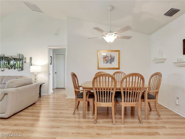 dining space with vaulted ceiling, light hardwood / wood-style floors, and ceiling fan