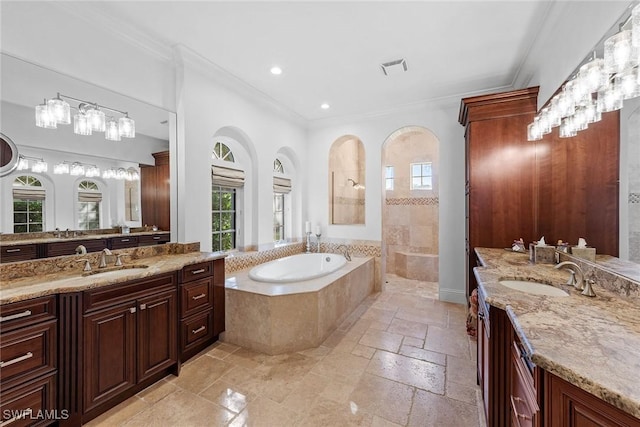 full bathroom with crown molding, a sink, a wealth of natural light, and stone tile floors