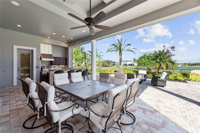 view of patio / terrace featuring outdoor dining space, an outdoor kitchen, and a ceiling fan