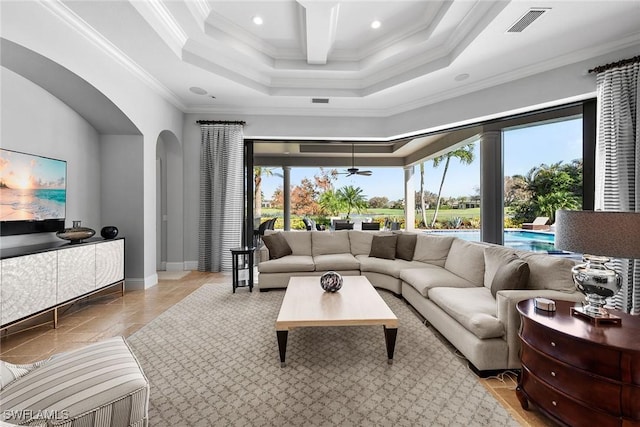 living room with arched walkways, plenty of natural light, visible vents, and crown molding