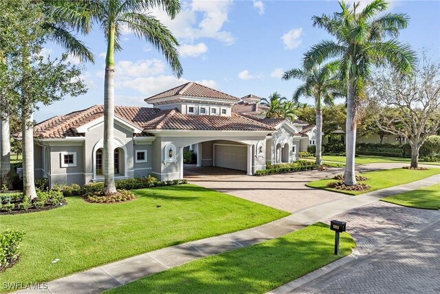 mediterranean / spanish home with a front yard and a carport