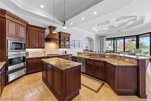 kitchen with custom range hood, stainless steel appliances, a sink, and a center island