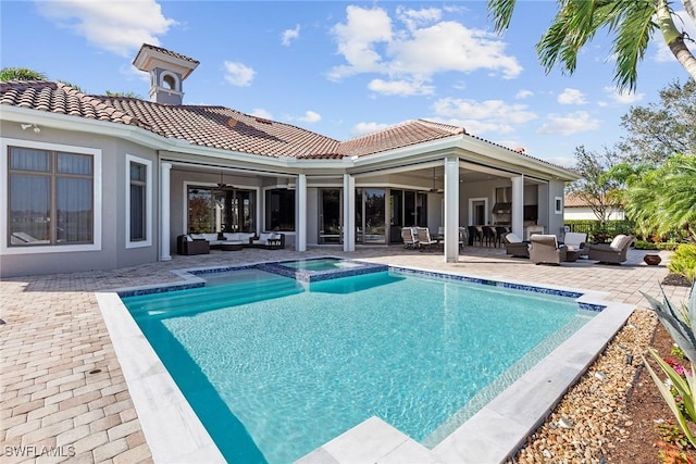 view of pool featuring a patio area, ceiling fan, and outdoor lounge area