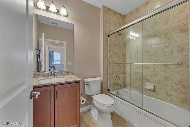 full bathroom featuring vanity, bath / shower combo with glass door, toilet, and tile patterned floors