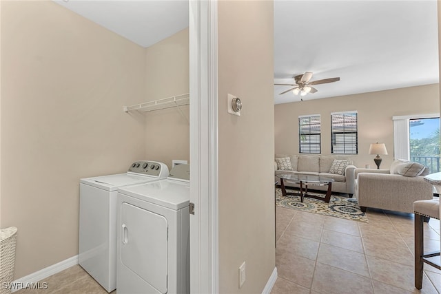 washroom featuring ceiling fan, washing machine and dryer, and light tile patterned flooring