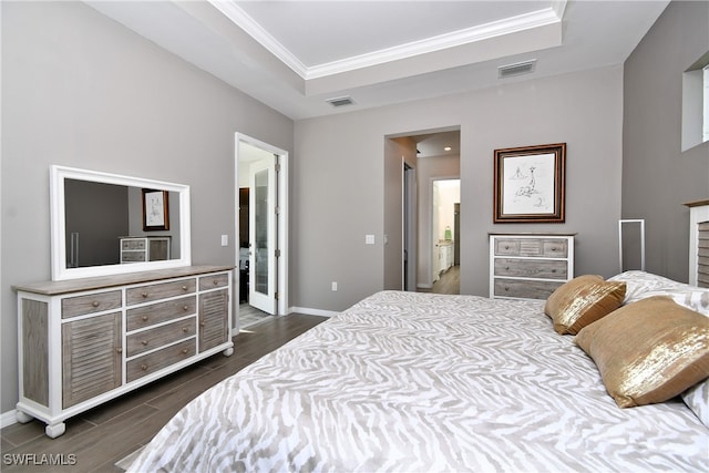 bedroom with a raised ceiling, dark hardwood / wood-style flooring, and ornamental molding