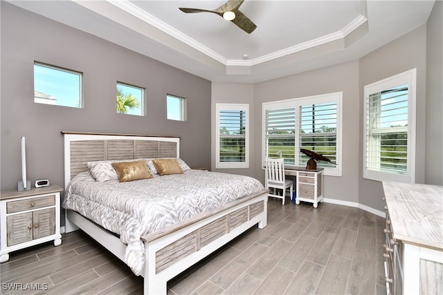 bedroom with a tray ceiling, ornamental molding, and ceiling fan