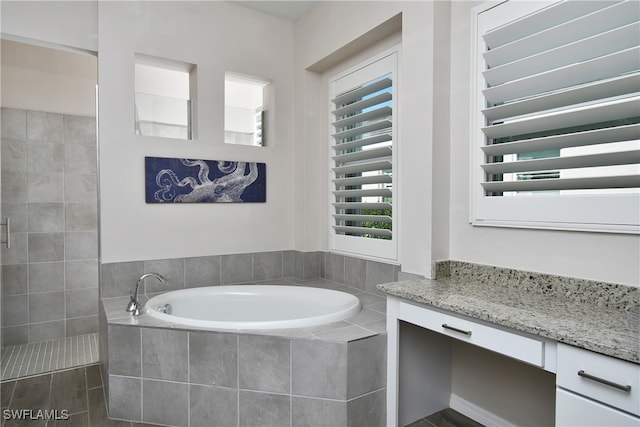 bathroom featuring separate shower and tub and vanity