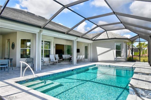 view of pool featuring an outdoor living space, a patio area, and a lanai