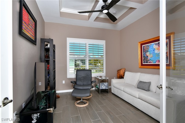 living room with coffered ceiling and ceiling fan