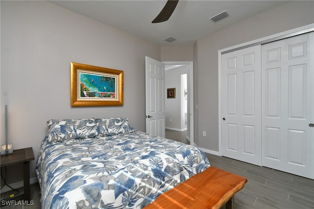 bedroom featuring dark hardwood / wood-style floors, a closet, and ceiling fan