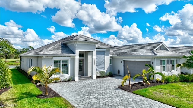 view of front facade with a garage and a front lawn