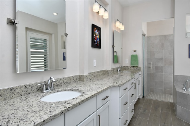 bathroom with vanity, wood-type flooring, and walk in shower