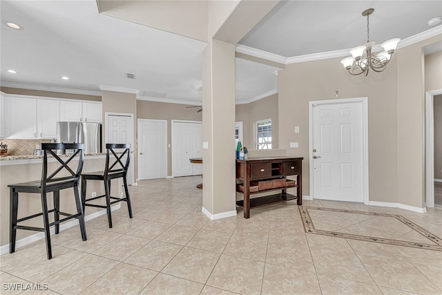 tiled entrance foyer with crown molding and ceiling fan with notable chandelier