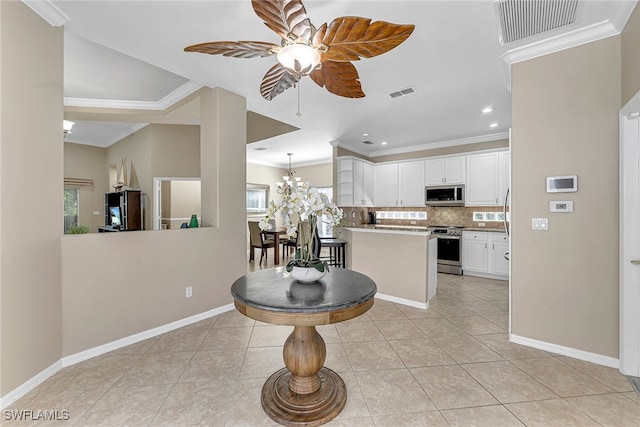 kitchen featuring white cabinetry, stainless steel appliances, light tile patterned floors, and a healthy amount of sunlight