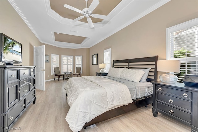 bedroom featuring ceiling fan, crown molding, a raised ceiling, and light hardwood / wood-style floors