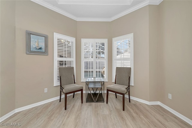 sitting room with crown molding and light hardwood / wood-style flooring