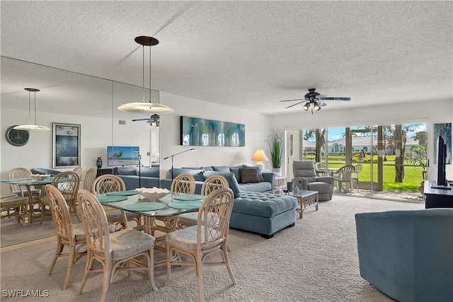 dining space with carpet flooring, a textured ceiling, and ceiling fan