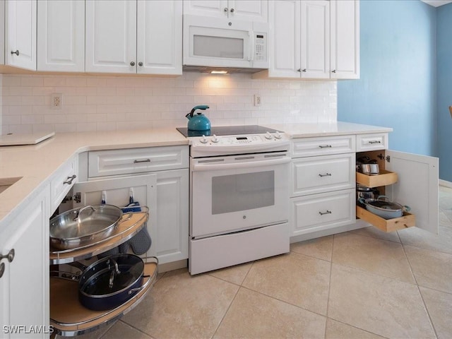 kitchen with white cabinetry, light tile patterned flooring, white appliances, and tasteful backsplash