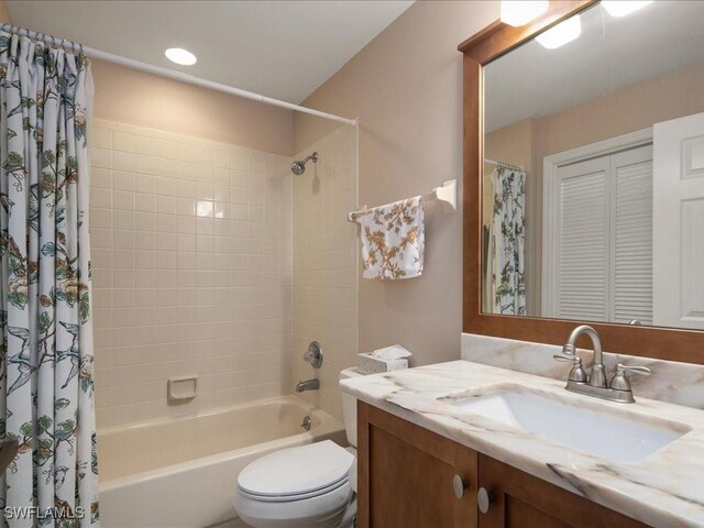 full bathroom featuring vanity, toilet, and shower / tub combo