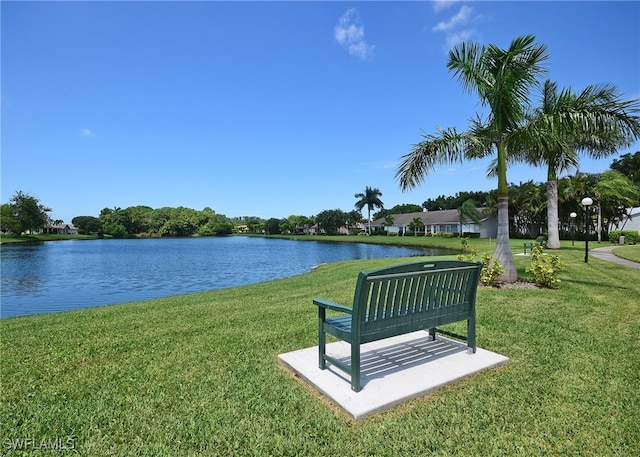 view of community featuring a lawn and a water view