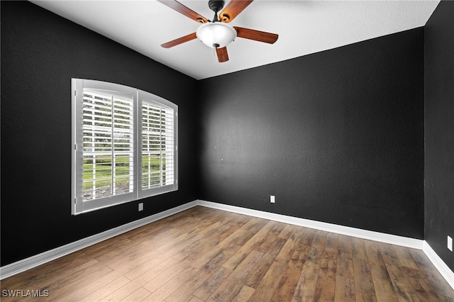 unfurnished room with hardwood / wood-style floors and ceiling fan