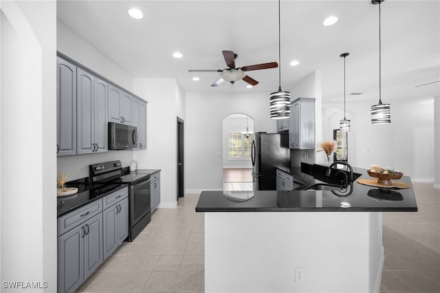 kitchen with gray cabinets, hanging light fixtures, sink, and stainless steel appliances